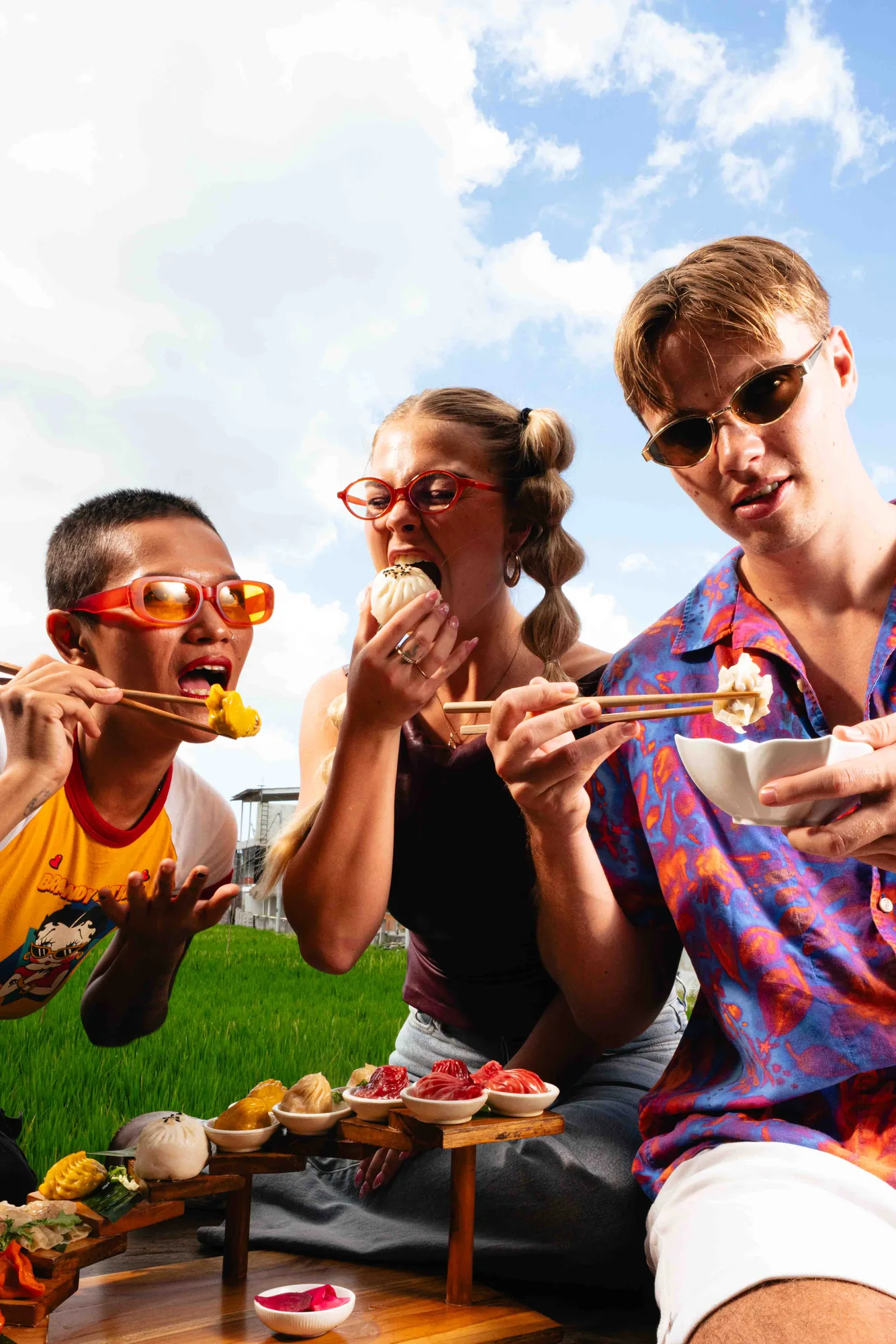 Three friends sharing a dumpling flight at a table