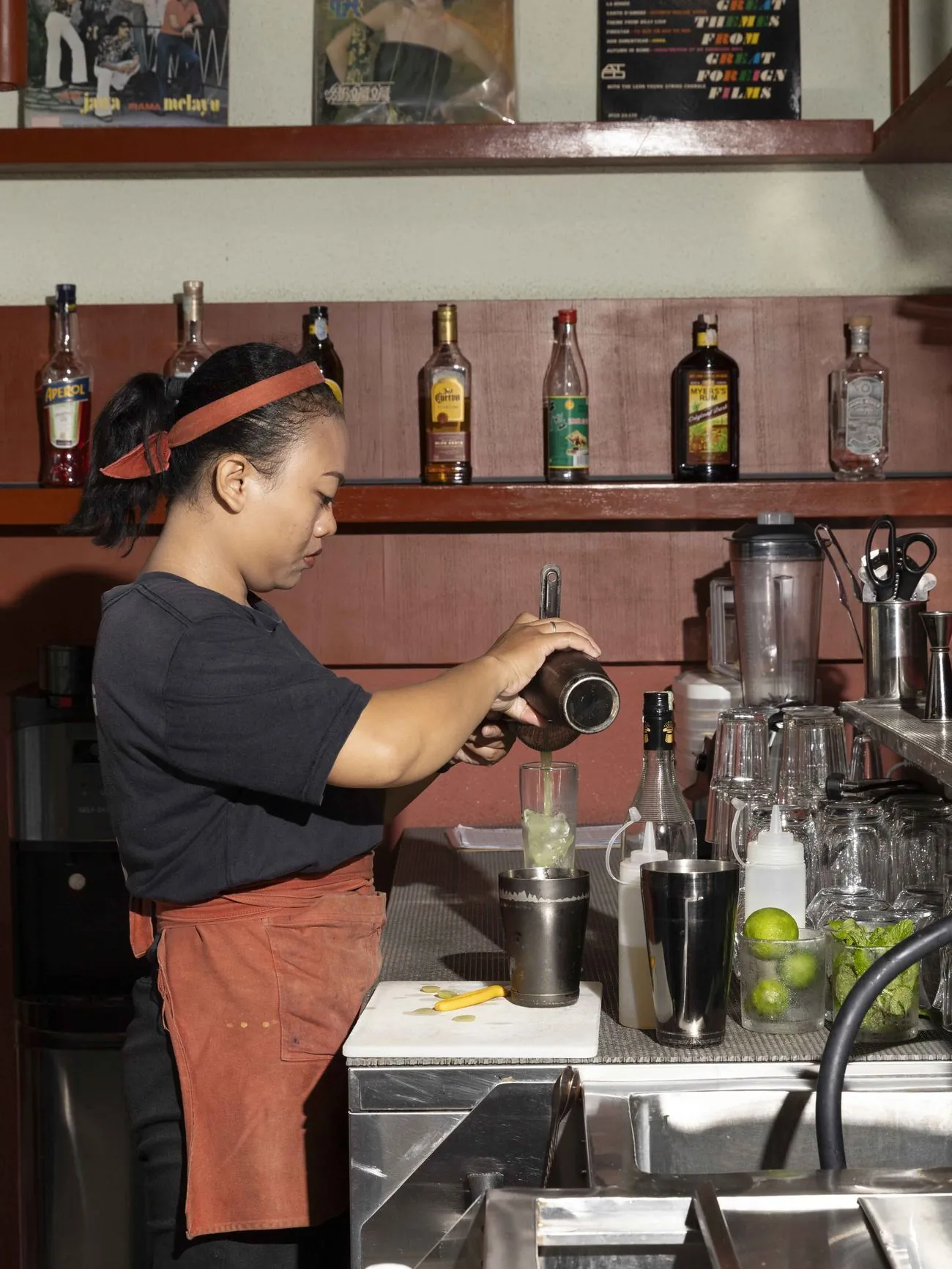 Sista Dumpling staff member holding fresh steamer baskets in the kitchen